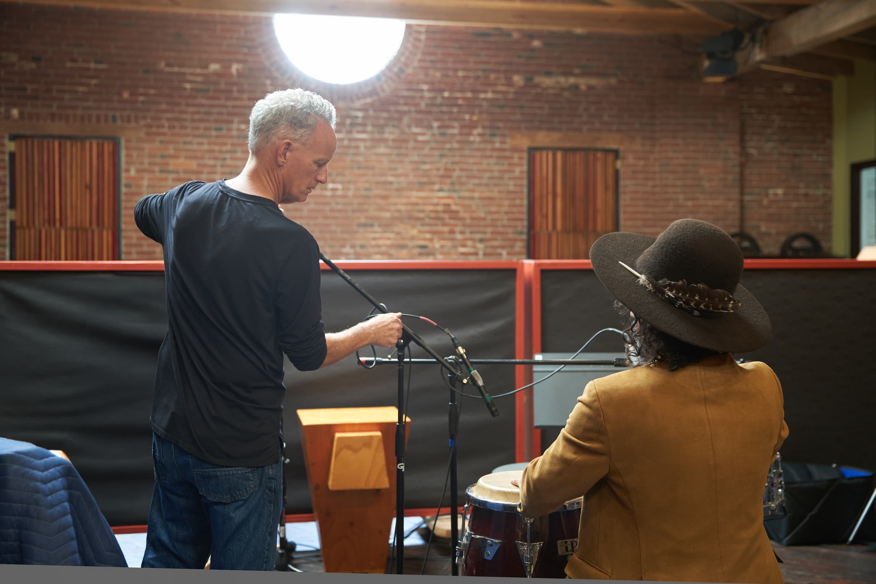 Engineer setting up microphones for a live band session